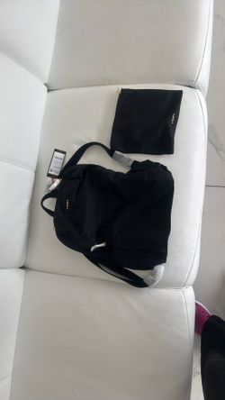 TUMI Black Just In Case Backpack. 98% Nylon With 2% Leather Trim And 100% Polyester Lining.