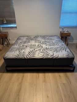 Like new king size Sealy Posturepedic Plus mattress and a modern bed frame