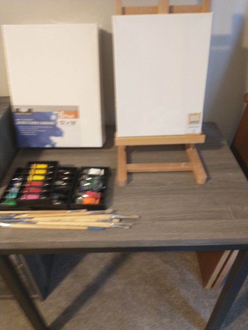 Art table with easel,Some Paint,brushes and Canvases