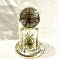 Vintage (Sharp) swinging pendulum battery operated clock. 12 inch tall plastic dome.
