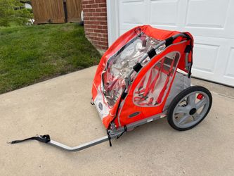 InStep Take 2 Double Bike Trailer in orange and gray, featuring a 2-in-1 bug screen & weather shield.