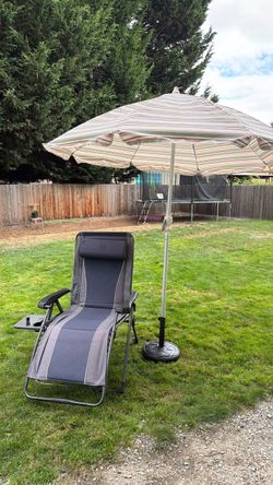 Comfortable chair and big umbrella in good condition