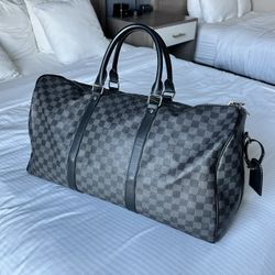Authentic Louis Vuitton Keepall Bandoulière 55 in the sleek Damier Graphite canvas