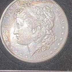 1881/s Silver Morgan With His A Slight Rainbow Monogram Crescent Tone On Front