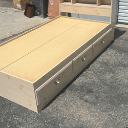Kids twin size bed with bookcase headboard, and three drawer storage