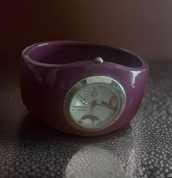 Bay Studio quartz watch features a vibrant purple hinged cuff band