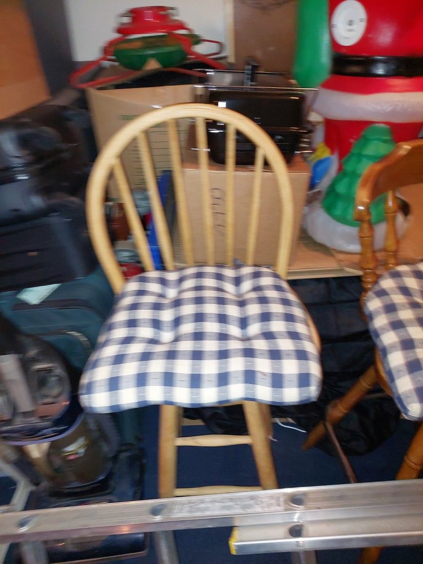 3 bar stools with cushions 2 like 1 different.