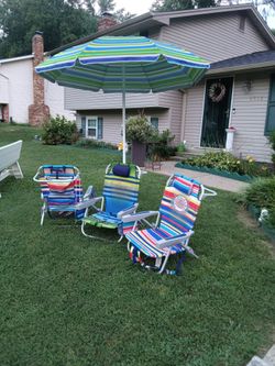 Three beach chairs and one umbrella