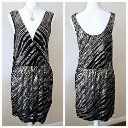 Size Medium Express Black and Gold Sequined Sleeveless Tank Asymmetrical V Neck Dress. 92% Rayon, 8% Spandex. Lining 100% Polyester. 16" Pit to Pit & 