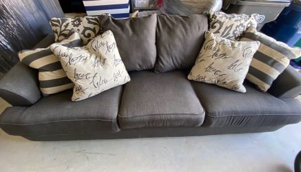 2 Ashley Furniture couches and pillows.