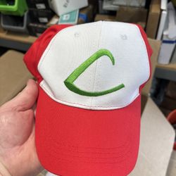 Red and White Cap with Green Logo  Stylish red and white cap featuring a green logo on the front.