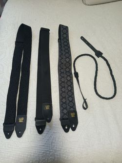 Assorted guitar straps and a mandolin strap