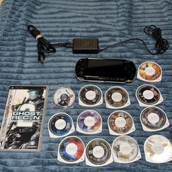 PSP with charger and 14 games.
