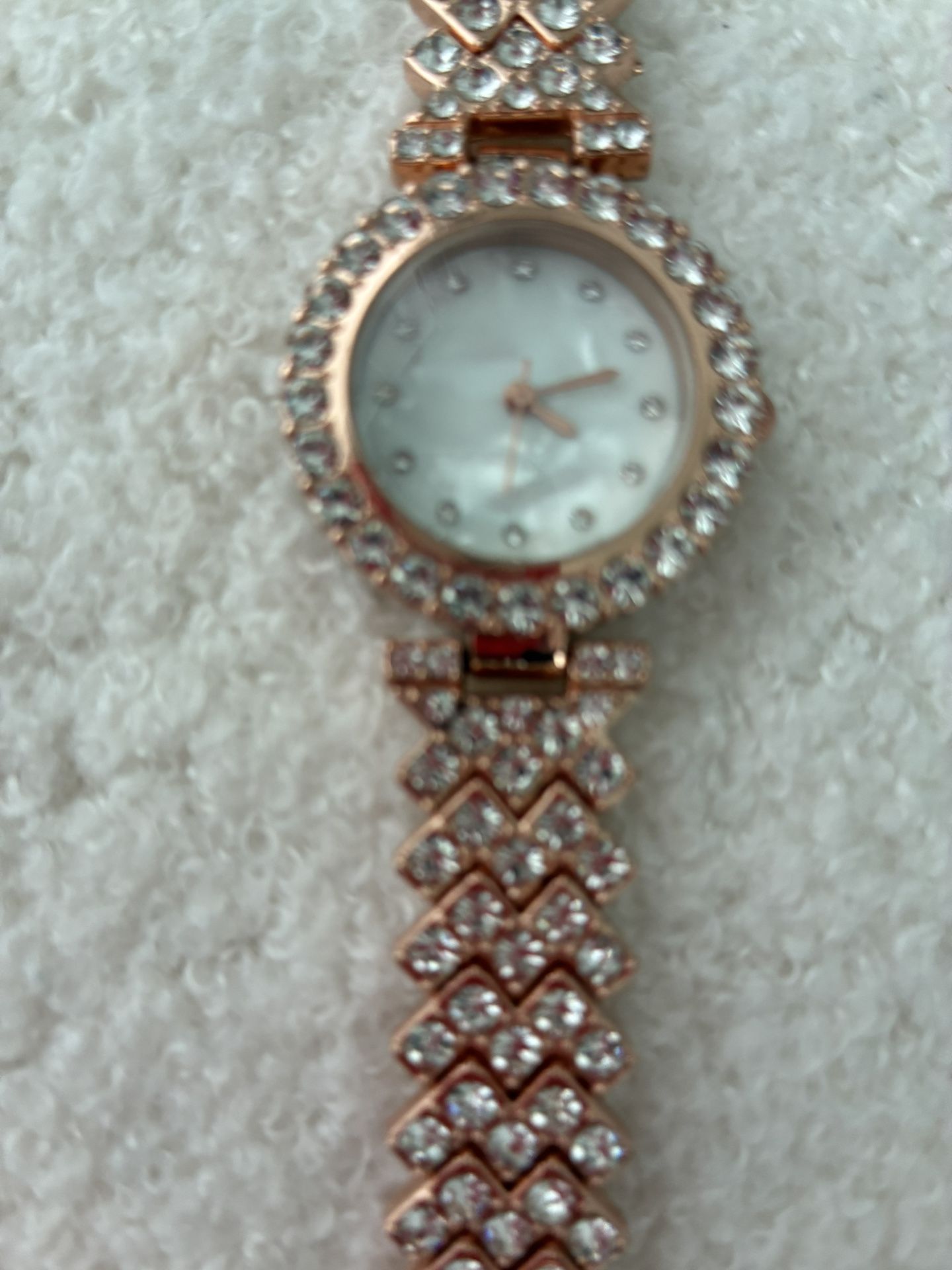 Reduce price. Rose gold watch with rhinestone band.