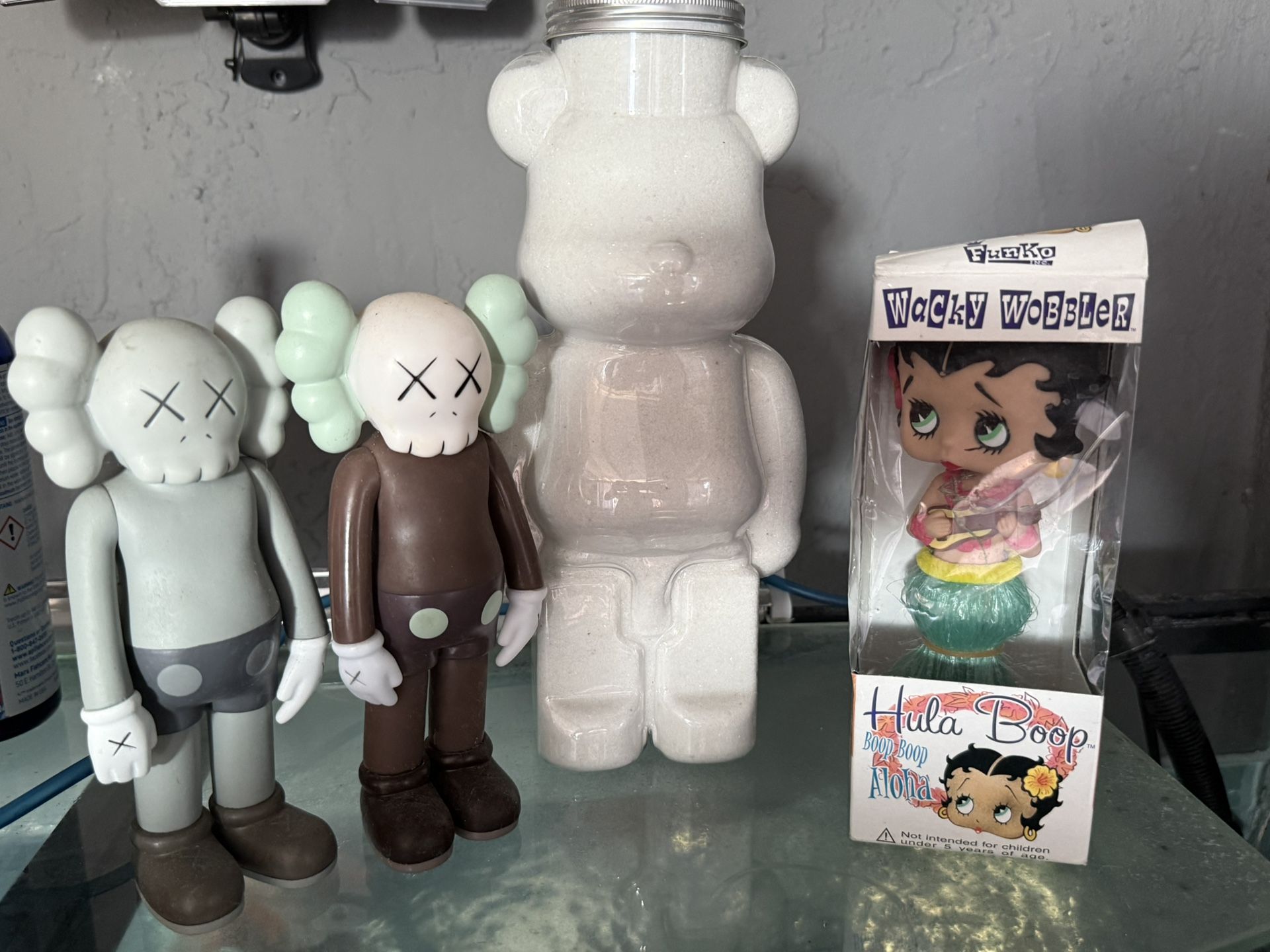 2 KAWS figure , BearBrick & Funko Wacky Wobbler featuring Betty Boop in a Hula Aloha outfit.