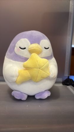 BK7552-6” purple penguin holding a yellow star