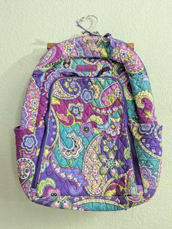 Very nice quilted Vera Bradley small backpack featurinpg a vibrant purple and teal paisley floral pattern.