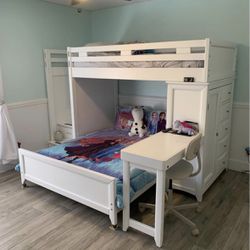 White bunk bed with chest, steps and desk.