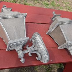 outdoor wall lantern sconces, featuring a distressed grey or antique finish ( Minka Group)