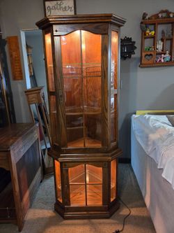 Lighted Oak corner curio cabinet with 3 glass shelves