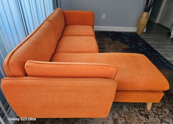 Like new. No stains, no tears, and completely clean. Mid-Century modern design with light wood legs. Includes a reversible chaise that can be position