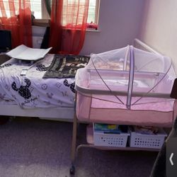 Pink bedside bassinet