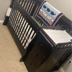 Dark Wood Baby Crib With Attached Changing Table And Clothing Storage 