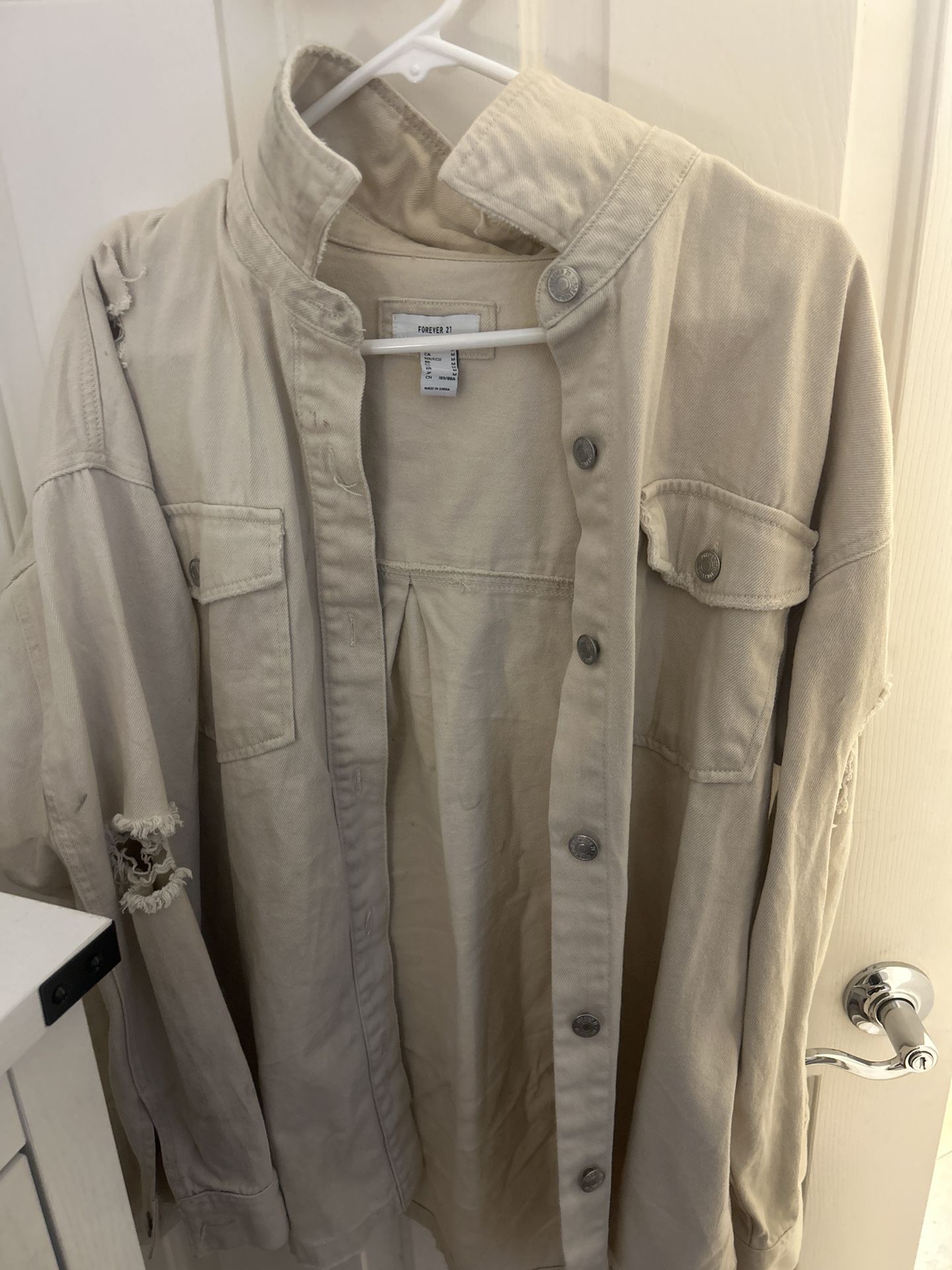 Distressed beige denim jacket