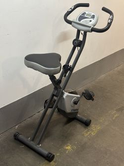 The Stamina Folding Exercise Bike 182 is a compact, affordable indoor upright stationary bike featuring eight levels of quiet magnetic resistance, bui