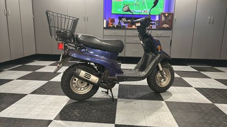 Blue Moped Scooter with Rear Cargo Basket