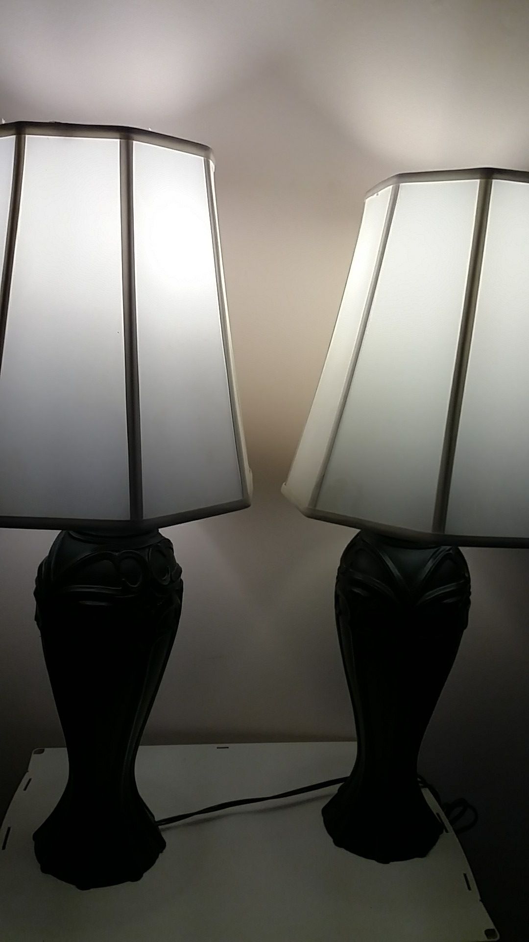 Two black lamps with shades