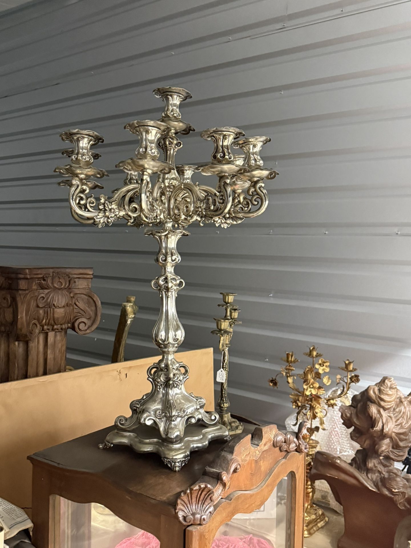 Ornate silver-plated candelabra with floral and acanthus leaf motifs. Candelabra, derived from the Latin word for 'candle,' are branched candlesticks 