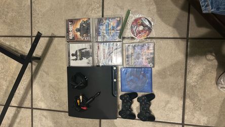 PS3 with 2 controllers and 7 games
