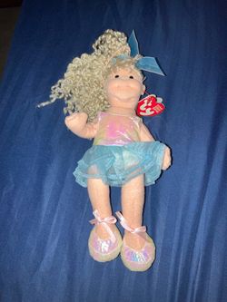 Ty Shy Shannon Teenie Beanie Bopper doll from 2002 featuring blonde curly hair and a blue tutu.Brand: TyCollection: Teenie Beanie BoppersCharacter: Sh