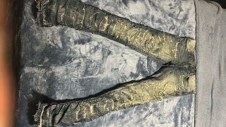 multi colored distressed stacked denim jeans