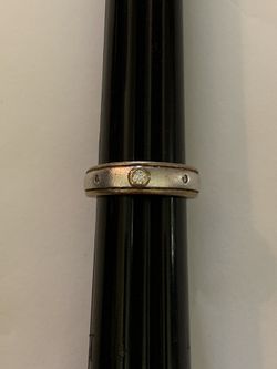 Sterling silver two tone silver and gold tone ring with matt finish and clear diamond type stones. Marked 925. Size 7