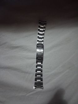 This is a genuine Rolex stainless steel watch bracelet clasp (and part of the bracelet) from a vintage Jubilee or Oyster-style band.