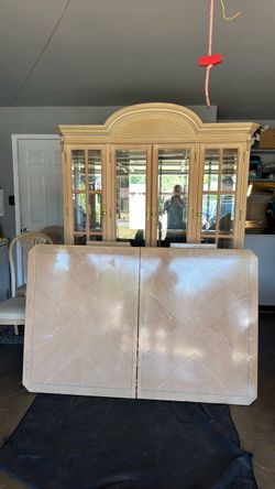 Table with chairs and lighted china cabinet