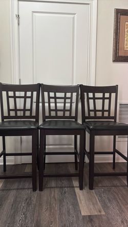 Three island chairs . The chairs are 26 inches. The colors of the chairs are brown.