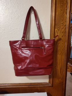 Kenneth Cole burgundy small little tear in the bottom
