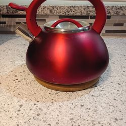 Red Metal Tea Kettle With Wood Trivet