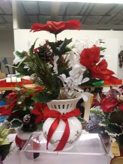 Holly vase arrangement with red ribbon