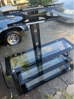 glass entertainment center with a TV mount