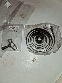 Antique clock key and a 15lb spring