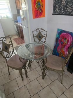 Glass table with 3 chairs.