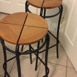 Black metal framed brown bar stools