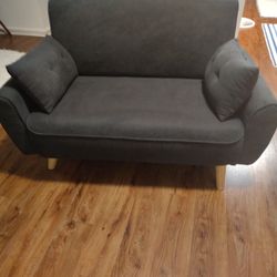 A CUTE LITTLE BLUE COMFORTABLE SOFA