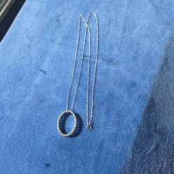 This item is a pavé diamond Oval pendant necklace, also known as an "eternity circle" necklace. The circular shape, combined with the diamonds