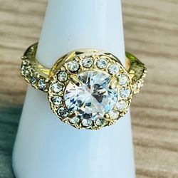 Vintage Elegant gold-tone halo ring featuring a brilliant clear crystal center and sparkling clear crystal accents. Designed to catch light and enhanc