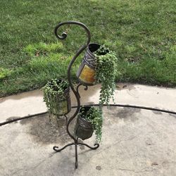 Whole lots of strings of pearls succulents in a 3 tiered planter